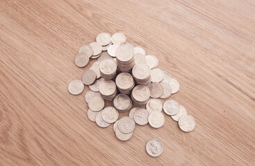 Obraz na płótnie Canvas Looking down shooting a pile of dollar coins on the table