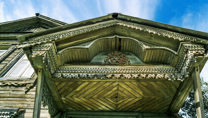 Canopy over the main entrance of an old Russian wooden house from the times of the Russian Empire....