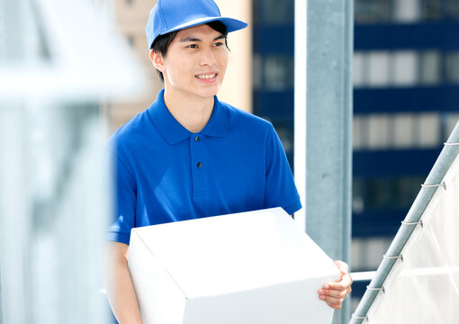 荷物を持つ配達員の男性