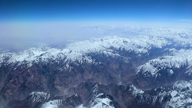 Aerial view of central Karakoram or Karakorum range in Pakistan, second highest mountain range in the world, with snowcapped mountains, peaks, valleys & glaciers.