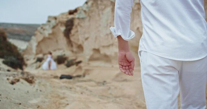 Young couple man and woman walking through the beach side and mountain they enjoying the moment together. 4k