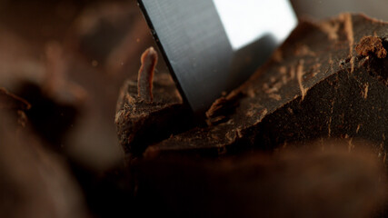 Detail of chisel cutting off raw chocolate