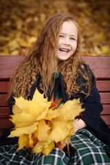 Irish little red haired girl laughing outdoor photo on fall landscape backgroun