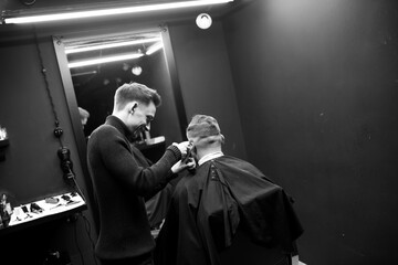 Haircut men typewriter close-up. Barber cuts a man.