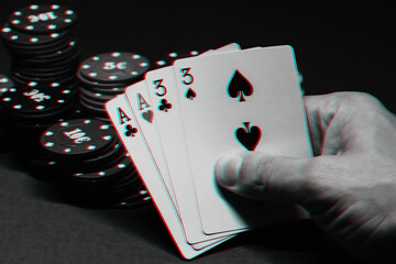 cards with two pairs in poker in the hands of a gambler on the background of gaming chips