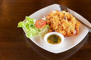 Tom Yum Fried Rice with Crispy Pork on wooden table