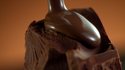 Detail of piece of chocolate with pouring hot chcocolate