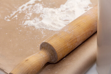 Rolling pin and flour on parchment paper