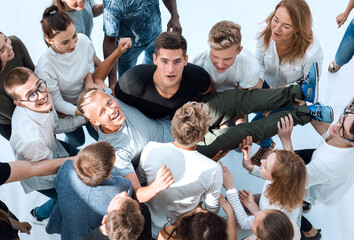 close up. a happy leader on the hands of his team