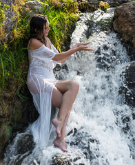 Beautiful young seminude woman in white transperent  dress enjoying summertime