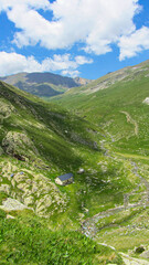 Fototapeta na wymiar Pyrenees summer scenery in a sunny day. Mountain range for hiking and trekking. Outdoor and adventure activities with mountain housing.