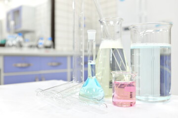 Selective focus of colorful liquid chemicals in glass beaker, flask and tube. Chemistry Laboratory class experiment background with copy space.