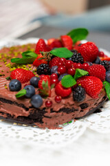 Vegan chocolate cake decorated with wild berries.
