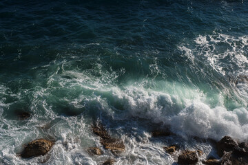 Ocean wave background breaking sea water rocky shore