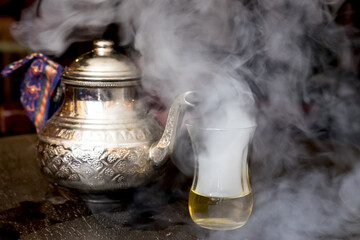 Vintage metal pot with hot traditional Morroccan tea