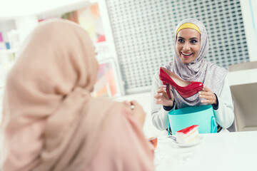 Young Arabian Women Sitting in Cafe in Modern Mall
