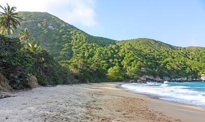 Caribbean beach with tropical forest in Tayrona National Park, Colombia. Tayrona National Park is located in the Caribbean Region in Colombia.