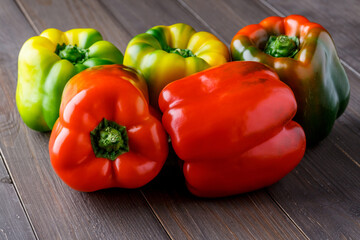 Fresh red, orange, green and yellow sweet bell paprika close up.fresh pepper on the table. background with bell peppers. Healthy lifestyle.