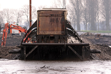 Obraz premium Truck unloading dredging spoil into a sediment storage basin