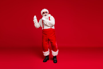 Fototapeta na wymiar Full length body size view of his he handsome cheerful cheery glad bearded Santa father hipster dancing having fun christmastime celebratory isolated bright vivid shine vibrant red color background