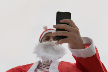 Santa Claus using the cell phone.