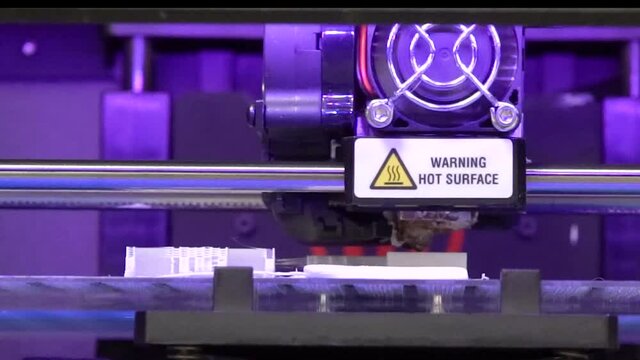 front view of a 3d printer making an industrial concept model.
