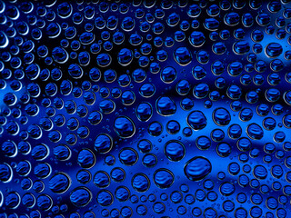 Water droplet in close up on blue background