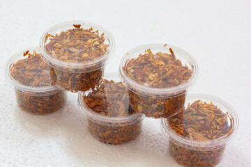 Pork Crackling Chilli Paste or Numphik is Thai food in the plastic can on white foam