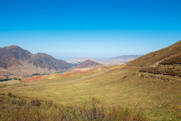 Mountain landscape. A hot summer day, red clay and burnt grass. Kyrgyzstan.