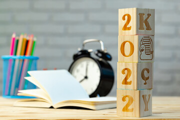 New Year 2022 wooden cubes on working table with stationery