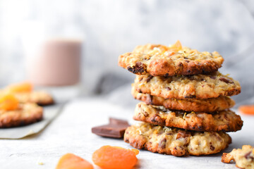 Oatmeal cookies. Homemade baking. Autumn concept of cookies with dried apricots and chocolate. Copy space. Light background.