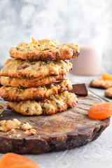 Oatmeal cookies. Homemade baking. Autumn concept of cookies with dried apricots and chocolate. Copy space. Light background.