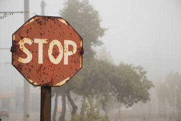 stop sign old rusty morning in the fog in dnieper city