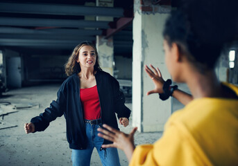 Teenage girl attacked by thugs in abandoned building, gang violence and bullying concept.