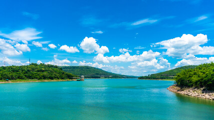 Panorama of Numerous wind turbines in the vast forest with mountains and sky as background at Lam Ta Khong Reservoir, Sikhio, Thailand.