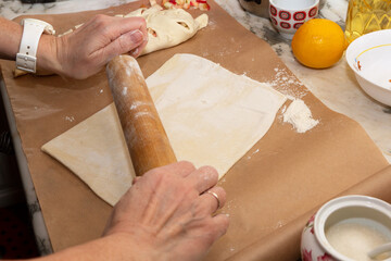 Raw dough and rolling pin on table