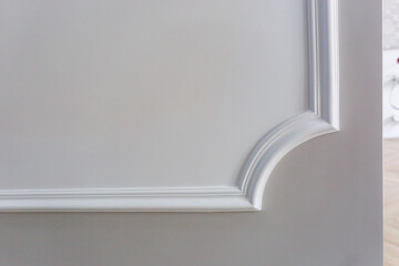 Detail of corner ceiling with intricate crown molding.