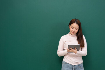 woman with tablet on green wall