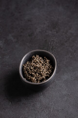 Sturgeon black caviar in black bowl on black background. Copy space. Close-up.