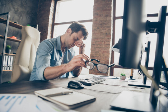 Portrait of his he nice attractive tired guy leader partner coding programming feeling bad overwork difficult task debug test qa at modern industrial interior loft brick style work place station