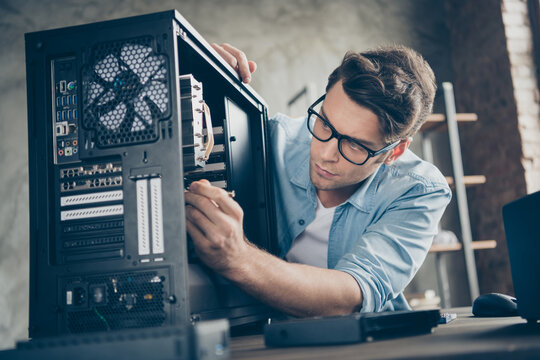 Close-up portrait of his he nice attractive focused professional guy skilled technician repairing hardware detail fan cooler support at modern loft industrial home office work workplace workstation