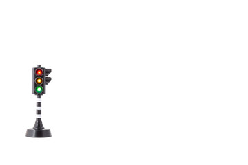 toy traffic light with all three lights lit on white background