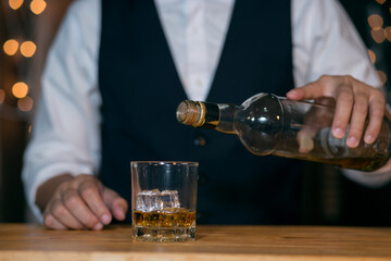 Barman pouring whiskey whiskey glass beautiful night