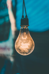 Old light bulb glowing in market close up