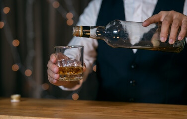 Barman pouring whiskey whiskey glass beautiful night