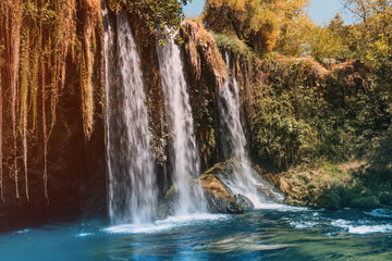 Fototapeta na wymiar The upper Dyuden waterfall is a unique natural wonder not far from the center of Antalya. Golden soft light in early autumn in Turkey