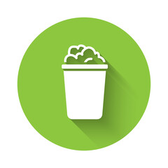 White Bucket with soap suds icon isolated with long shadow. Bowl with water. Washing clothes, cleaning equipment. Green circle button. Vector.