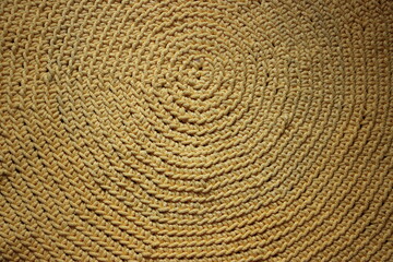 Wrinkled texture of golden yellow crochet handmade rug made of cotton. Small handmade business...