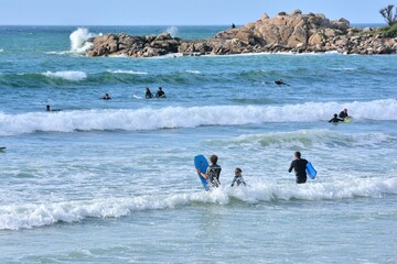 People practising surf on a beach in Brittany. France