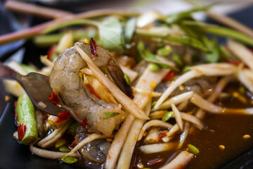 Papaya salad with fresh shrimp with fermented fish. Isaan food in Thailand